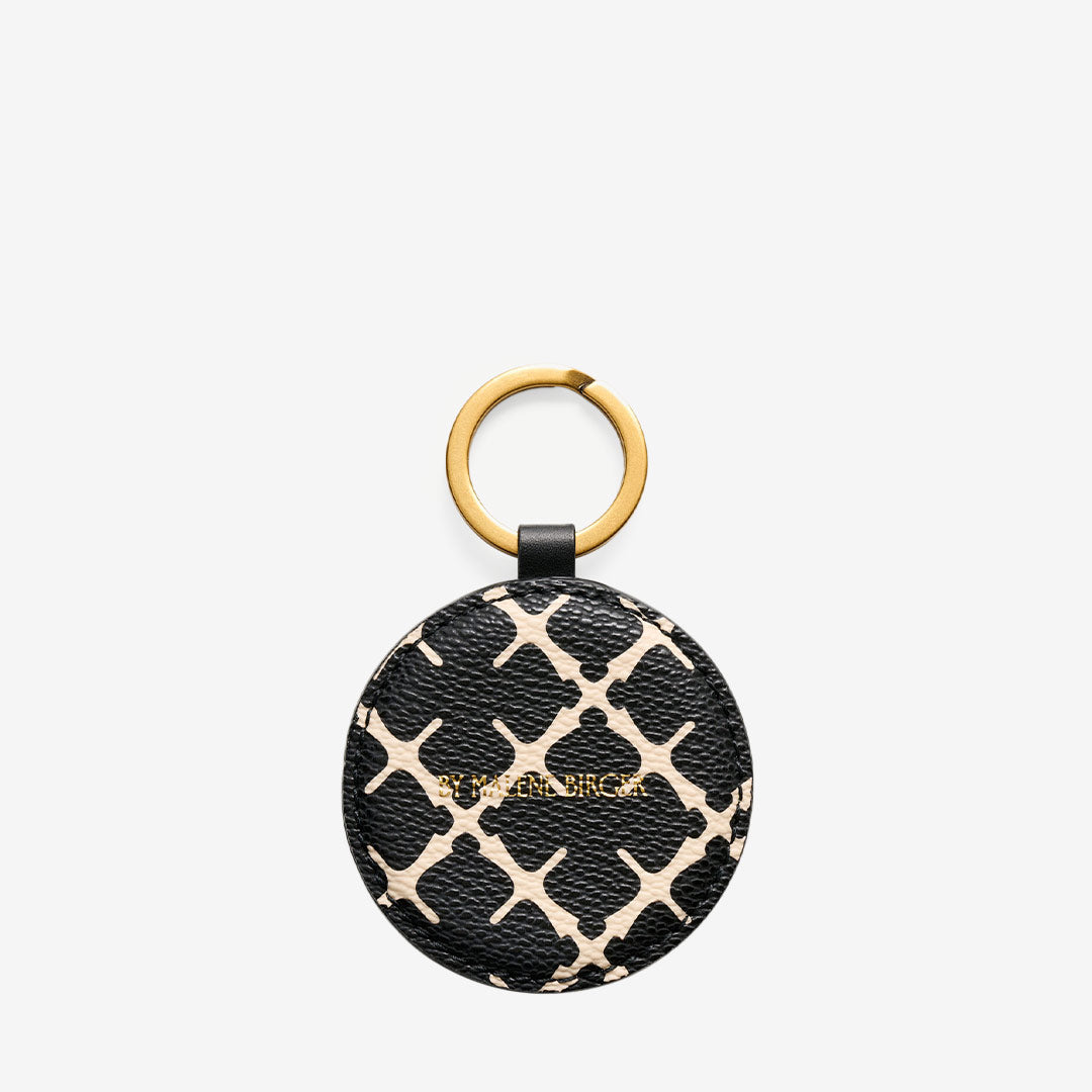 By Malene Birger Elia Keychain – svart nyckelring med Signature Flower-mönster och gulddetaljer