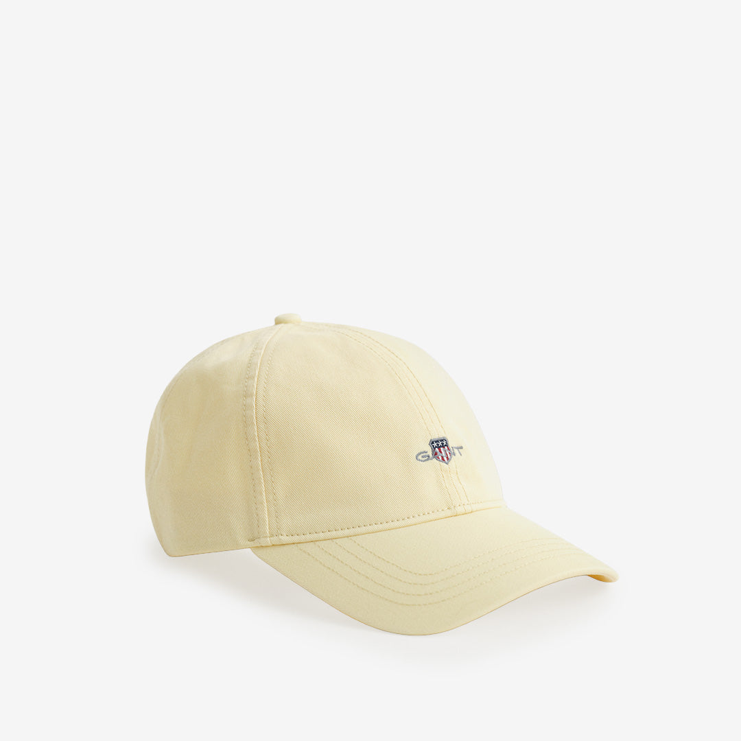 Sexpanelskeps från Gant i vanilla yellow med broderad shield-logotyp och justerbar rem