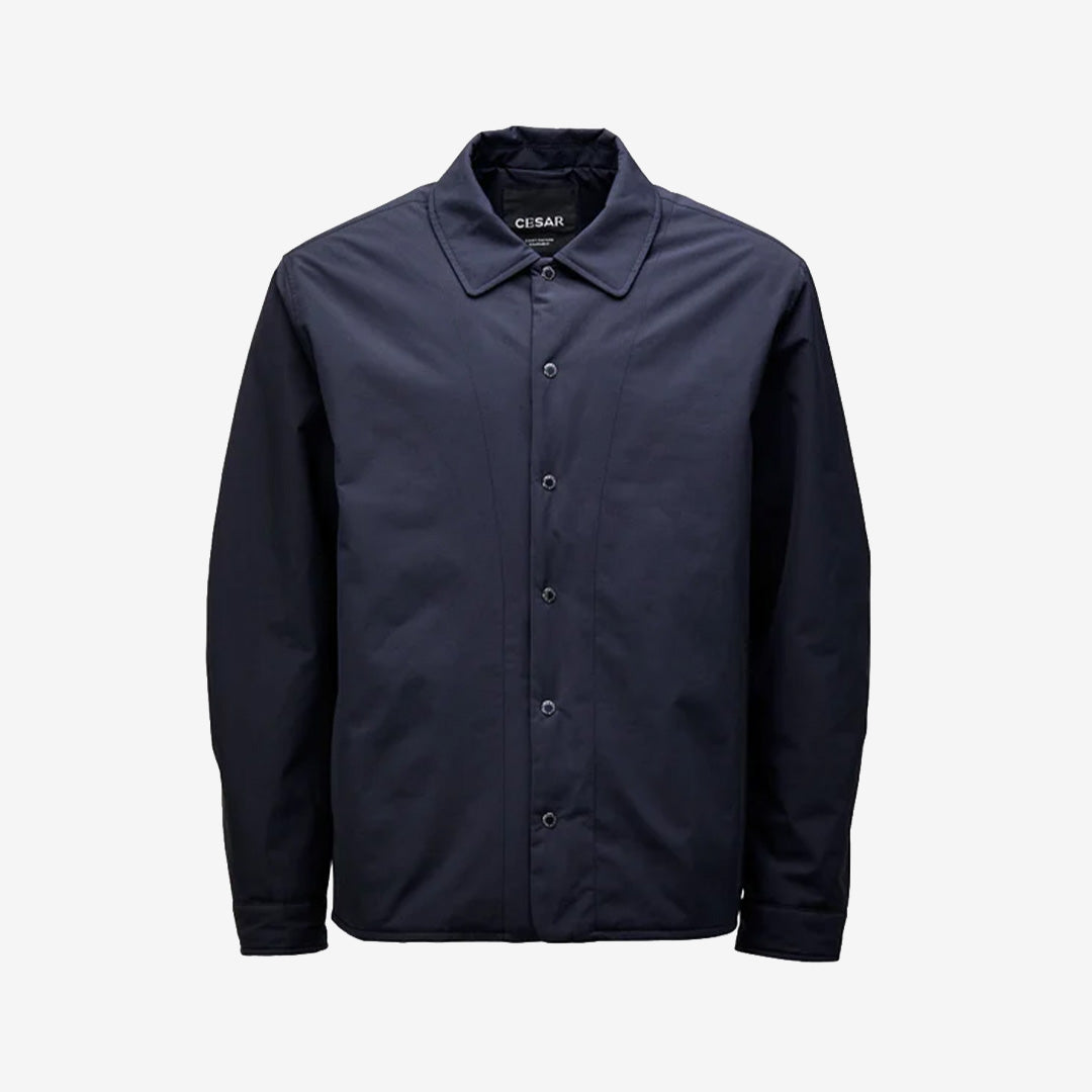 Navy hybrid-overshirt med quiltat foder och minimalistisk design i återvunnen nylon och ekologisk bomull