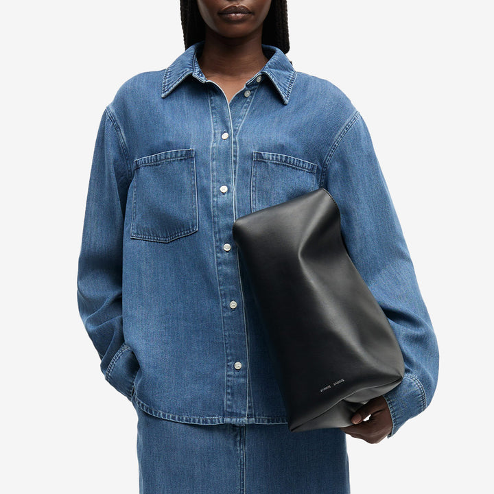 Långärmad denimskjorta från Samsøe Samsøe för dam i medium denim blue med bröstfickor.