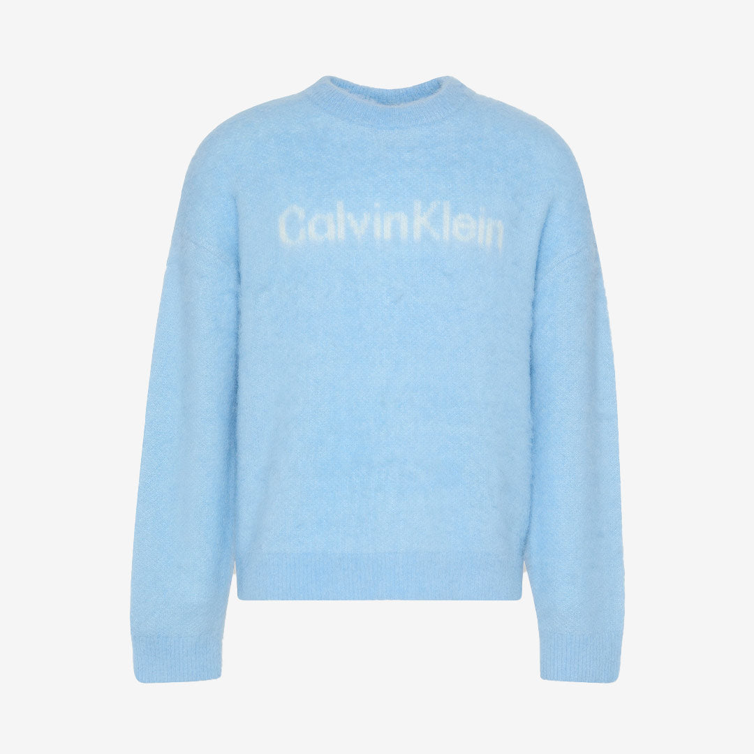 Ljusblå stickad ulltröja från Calvin Klein. Stor vit Calvin Klein text på bröstet